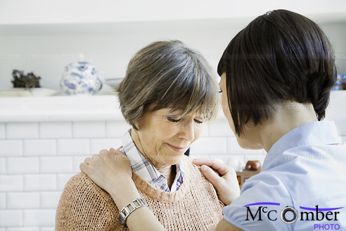 Stock Image: Senior woman getting emotional support from her daughter